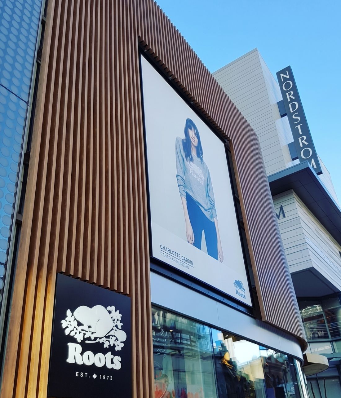 Timber-effect coated cladding on a retail facade