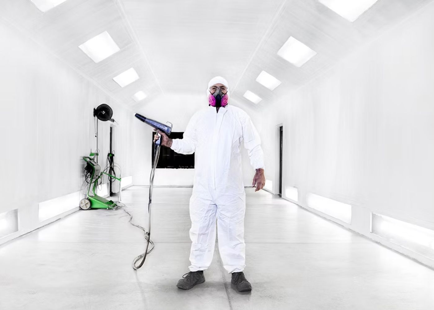 Operator inside the large batch paint booth